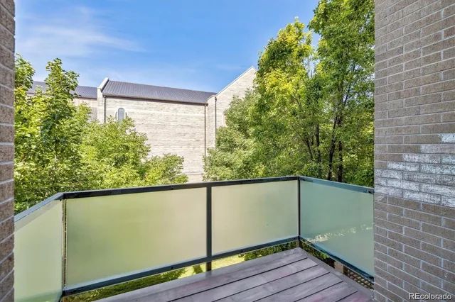 a view of a balcony with wooden floor