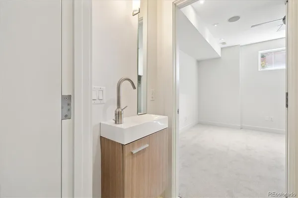 a close view of a sink a mirror and a vanity