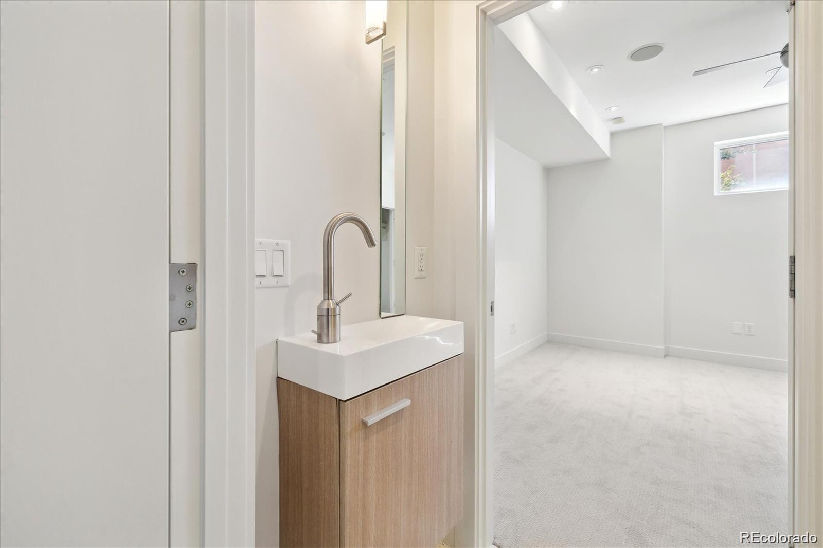 2312 South University Boulevard Denver, CO 80210 - Photo 14 of 23 a close view of a sink a mirror and a vanity