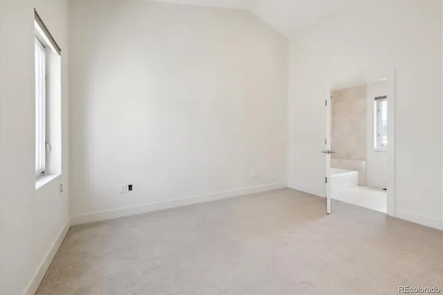 an empty room with white walls and window