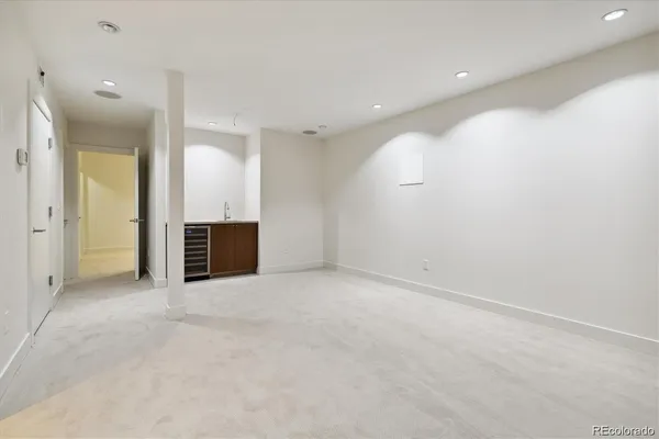 an empty room with kitchen and sink