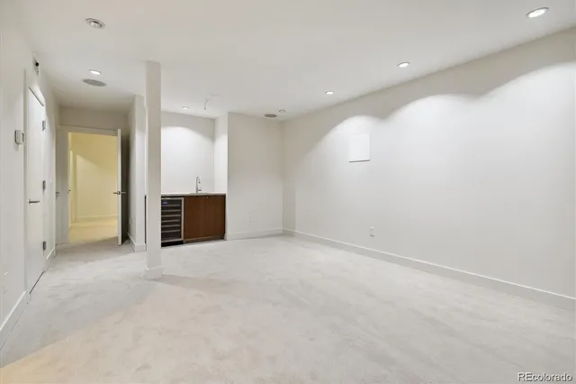 an empty room with kitchen and sink