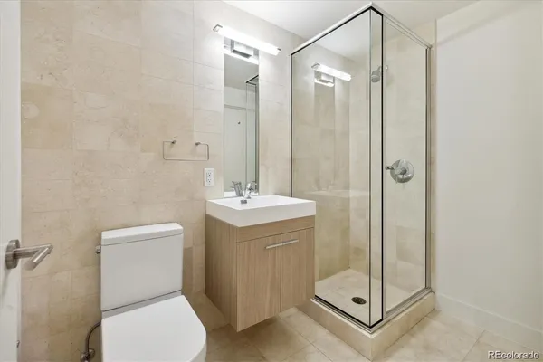 a bathroom with a shower a toilet and a sink