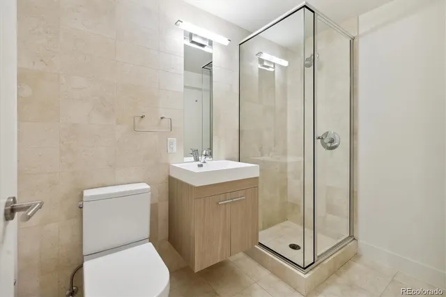 a bathroom with a shower a toilet and a sink