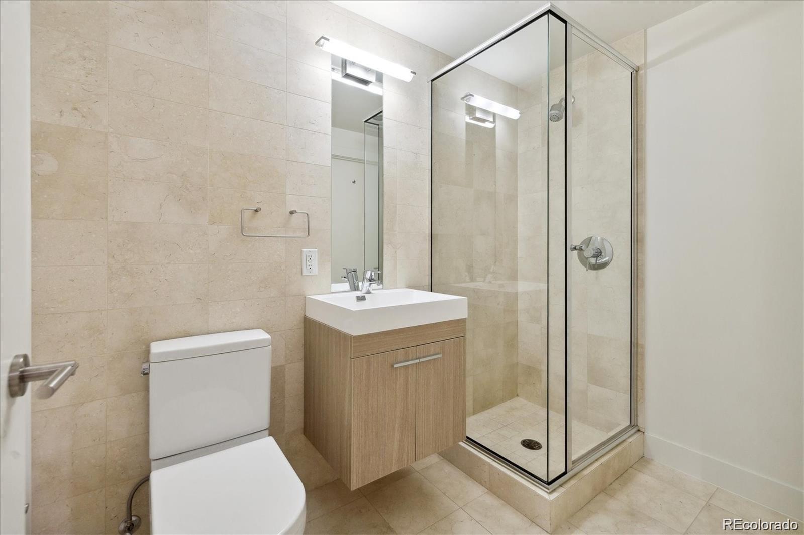 2312 South University Boulevard Denver, CO 80210 - Photo 21 of 23 a bathroom with a shower a toilet and a sink