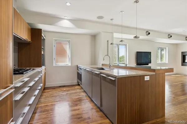a kitchen with stainless steel appliances granite countertop a stove and a sink