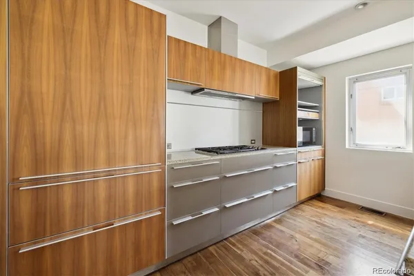 a room with wooden floor and electronic appliances