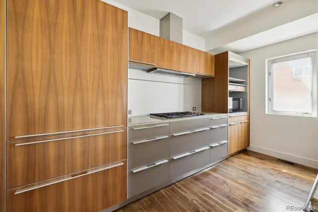a room with wooden floor and electronic appliances