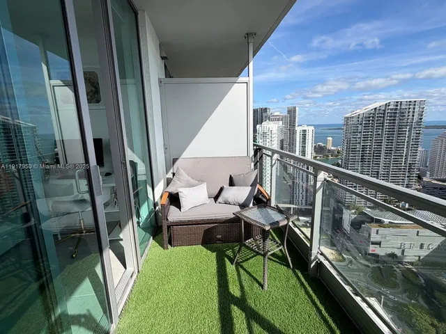 a balcony with table and chairs