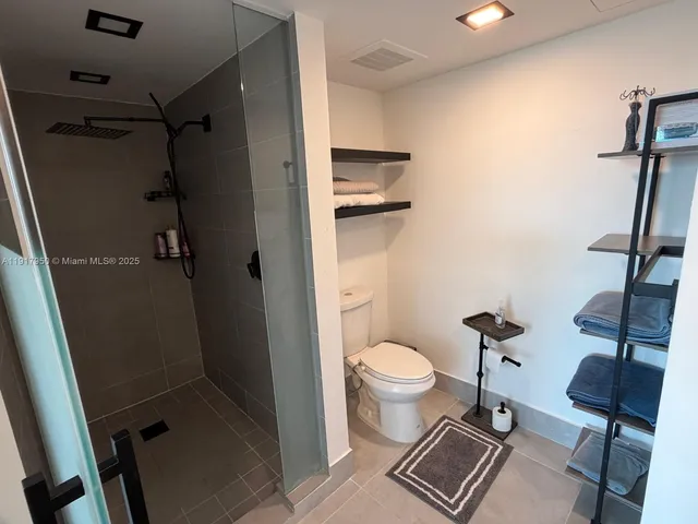 a bathroom with a toilet and a shower