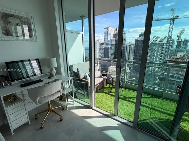 a reading room with furniture and a floor to ceiling window