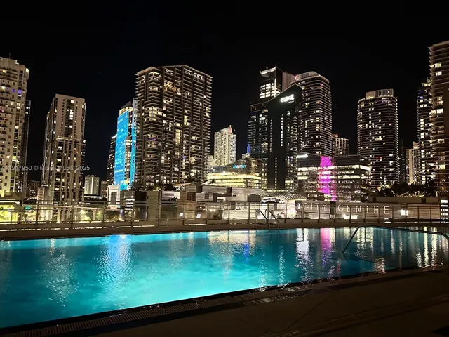 a work room with furniture and a floor to ceiling window