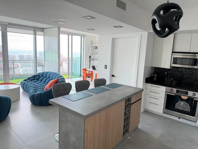 a bedroom with two beds and a large window