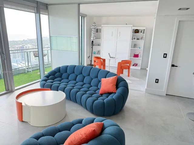 a living room with furniture and a large window