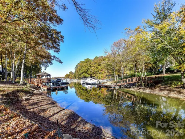a view of a lake with boats and trees around