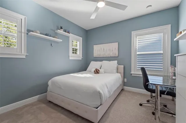 an aerial view of a house with a yard and lake view