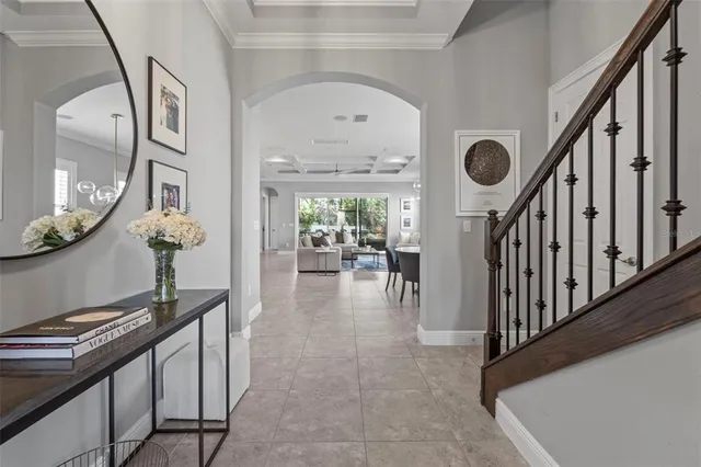 a view of a hallway with furniture and wooden floor