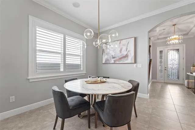 a kitchen with sink and chairs