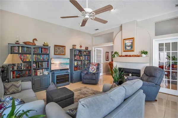 a living room with furniture a fireplace and a book shelf