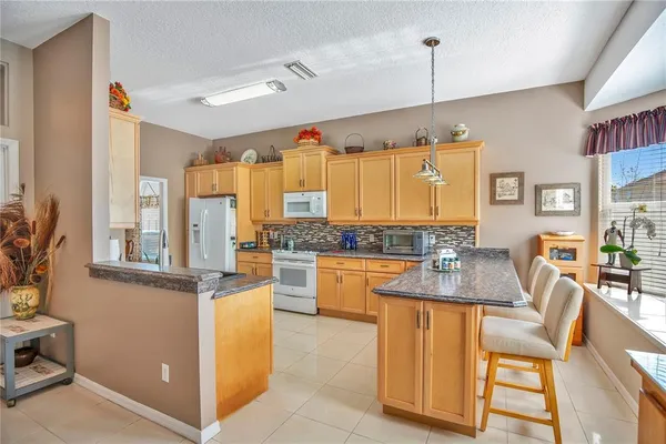a kitchen with stainless steel appliances granite countertop a stove and a refrigerator