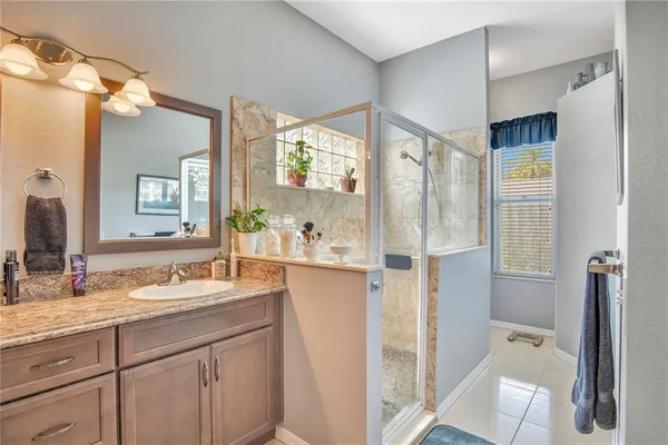 a bathroom with a granite countertop sink mirror and double