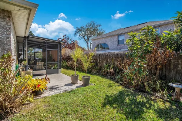 a backyard of a house with table and chairs