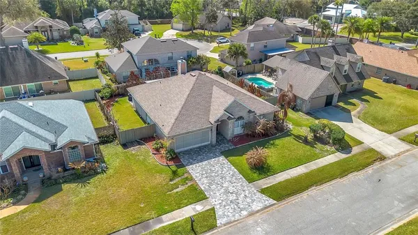 an aerial view of residential houses with outdoor space and river
