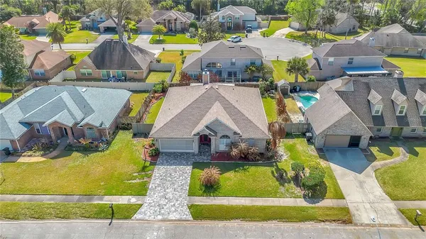 an aerial view of a house with a yard