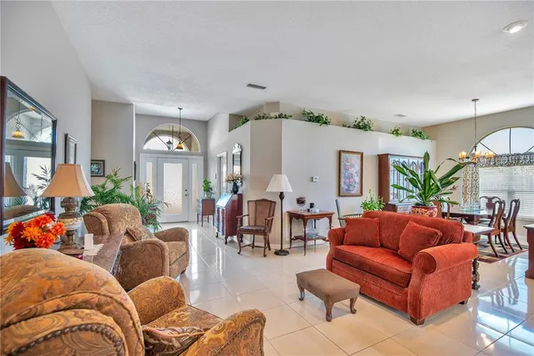 a living room with furniture and a chandelier