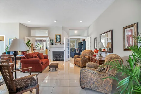 a living room with furniture fireplace and a window