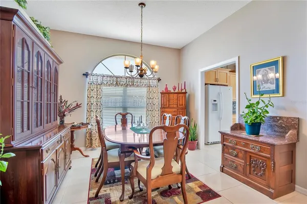 a view of a dining room with furniture and chandelier