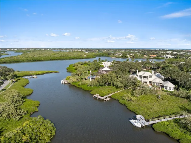an aerial view of a house with a lake view