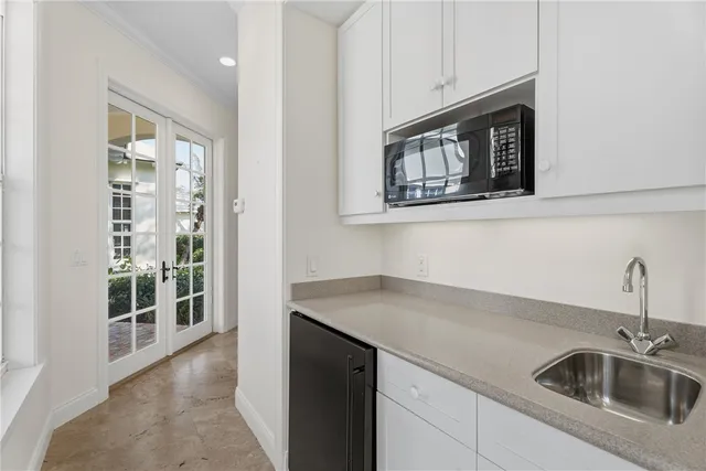 a kitchen with stainless steel appliances granite countertop a sink and a microwave