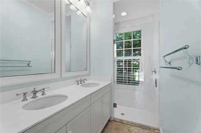 a bathroom with a shower sink and mirror