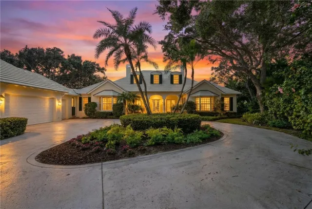 a view of a house with swimming pool and sitting area