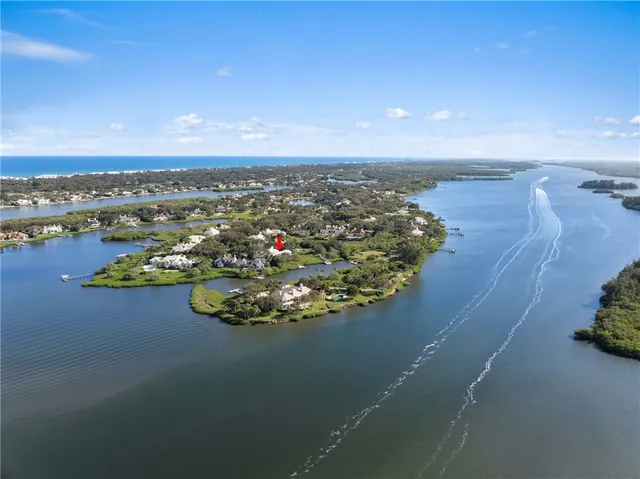 an aerial view of a house with a ocean view