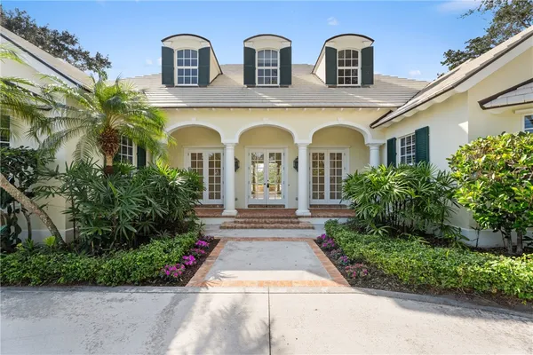 a front view of a house with garden