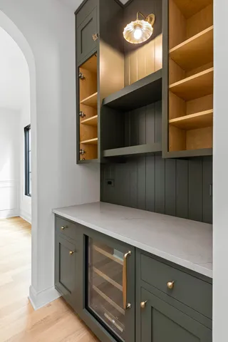 a kitchen with cabinets and wooden floor