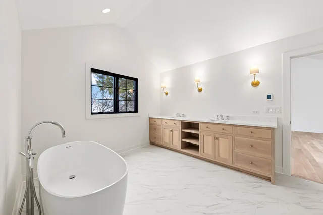 a spacious bathroom with a sink double vanity and a mirror
