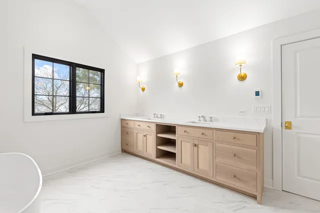 a spacious bathroom with a granite countertop sink and a mirror