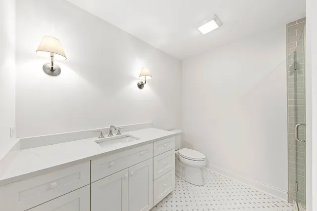 a bathroom with a shower sink and mirror