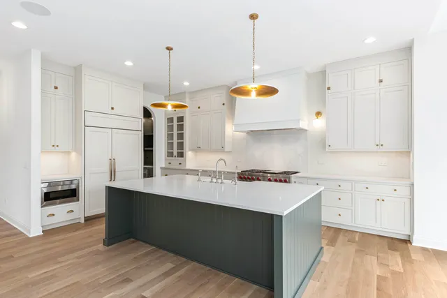 a kitchen with a sink stove and refrigerator
