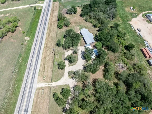 an aerial view of a house with a yard