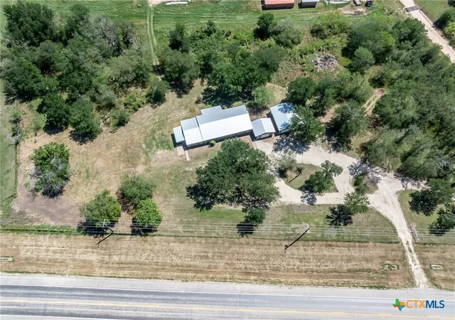 an aerial view of a house with yard and outdoor seating