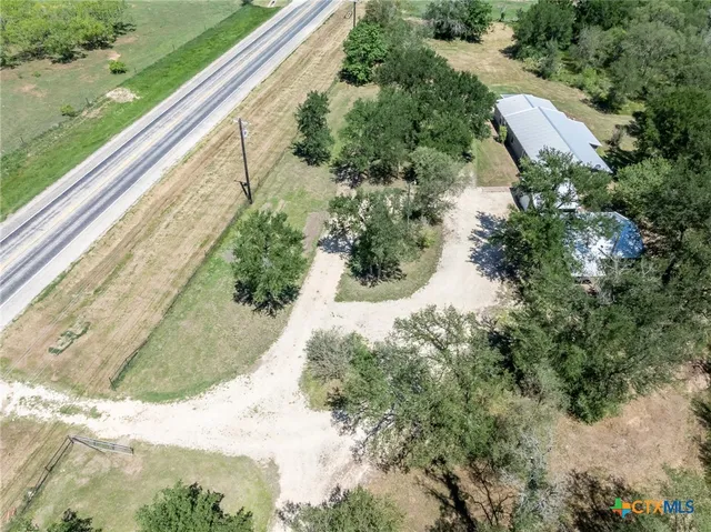 a view of a yard with potted plants