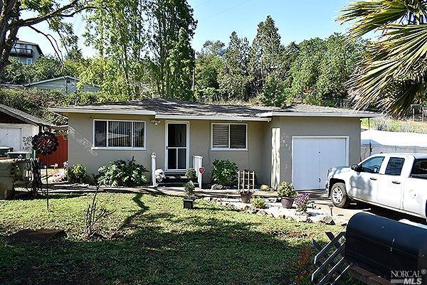 a front view of house with yard outdoor seating and barbeque oven