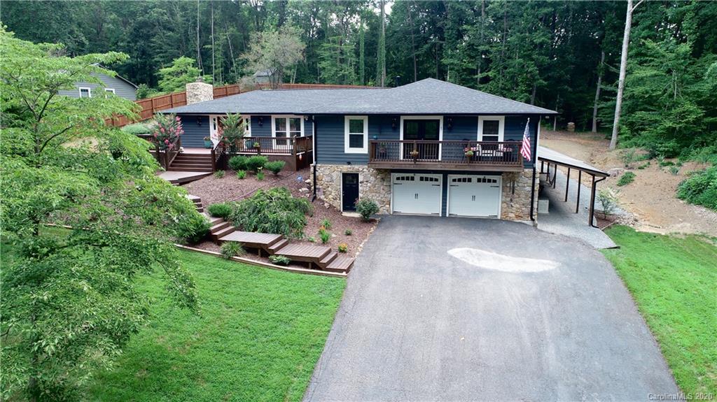 a view of a house with a yard and sitting area