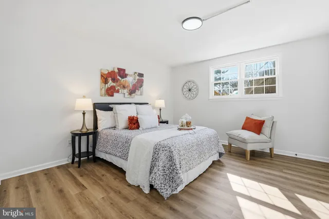 a bedroom with bed and painting on the wall