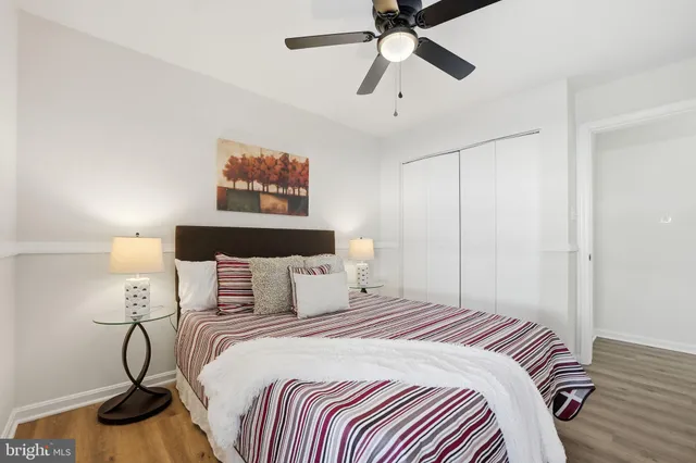 a bedroom with bed and wooden floor
