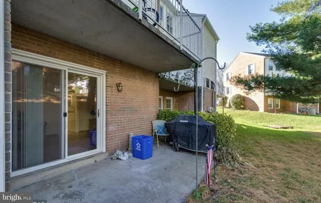 a view of a chair and table in backyard of the house
